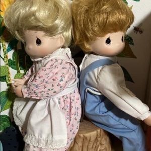 Precious Moments dolls on a log